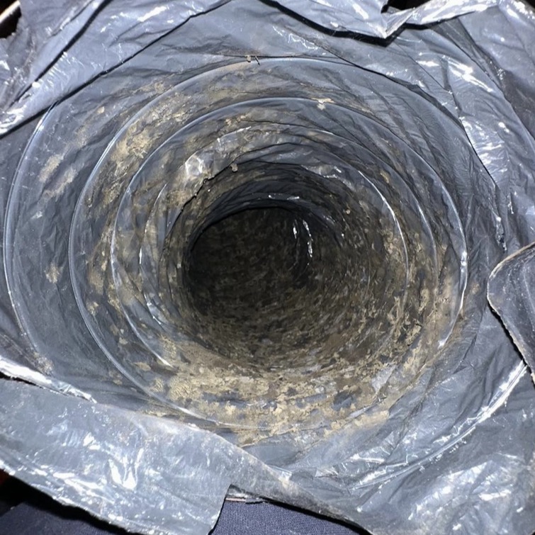 Air duct cleaning inspection photo showing dust and buildup